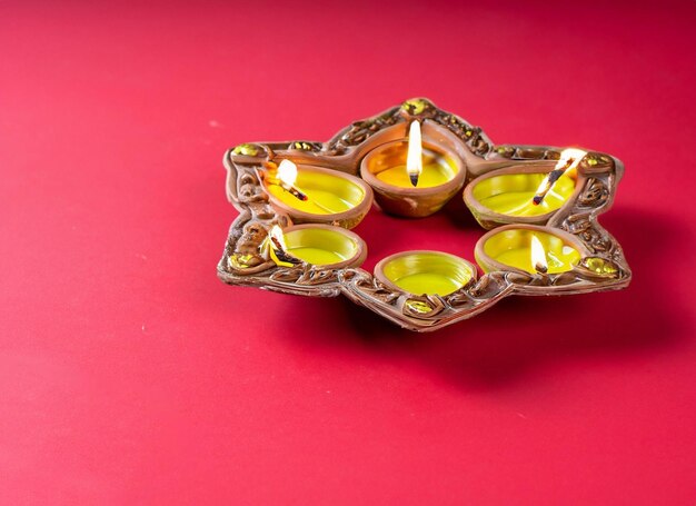 Diwali special triumph of lights and diwali symbols with diya light on wooden and solid background