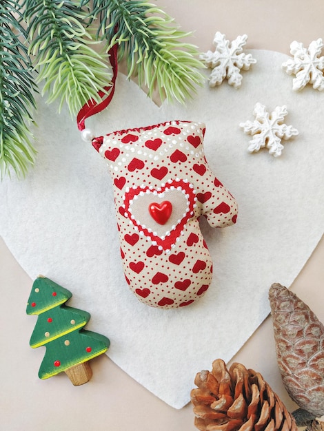 DIY beige soft mitten for Christmas decoration. Handmade baubles zero-waste Christmas