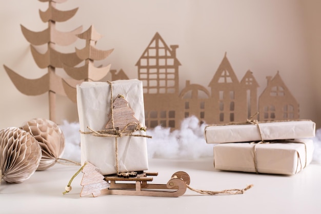 DIY Christmas home decor gift in craft paper on a sledge cardboard tree and house Handmade