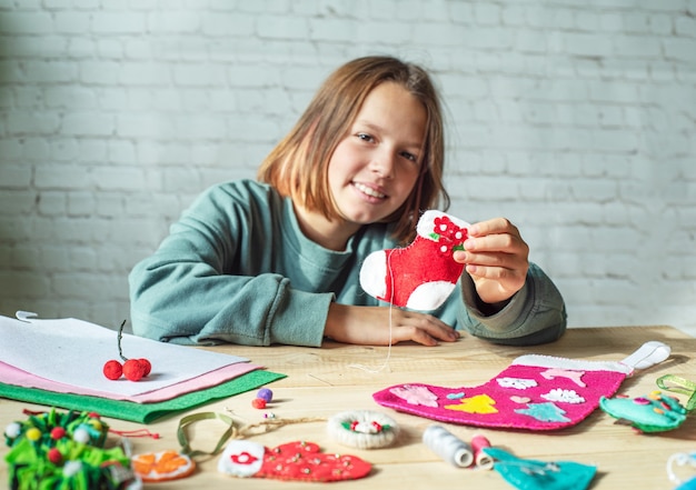 Diy christmas stocking, girl holding handmade felt christmas sock