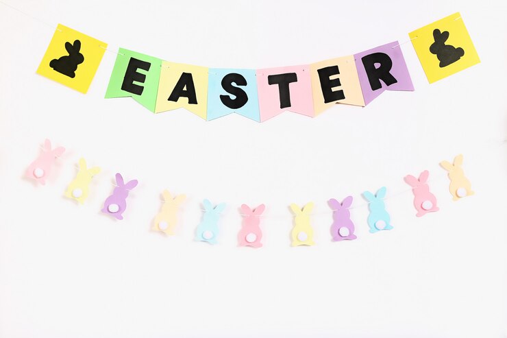 Photo diy easter garland bunnies, flags easter made paper white wall background