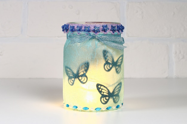 Photo diy fairy jar on white brick wall background. gift ideas, decor st february 14