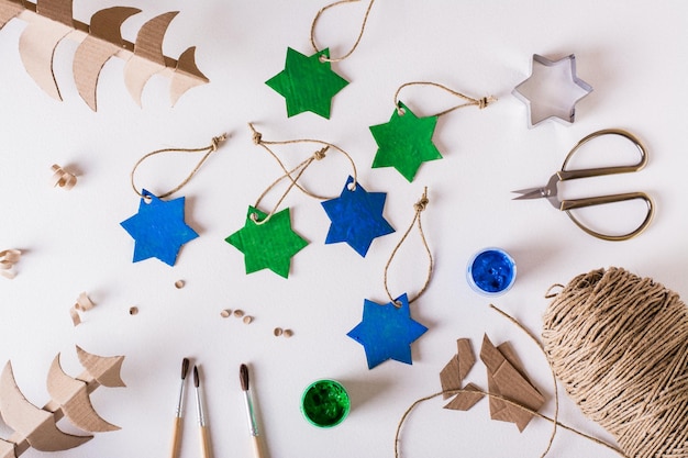 Diy handmade Christmas decorations gouachepainted cardboard stars Top view