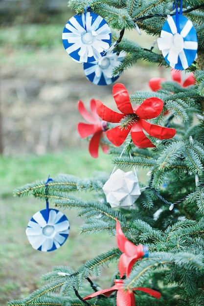 Decorazione fatta a mano fai da te fatta di carta e bottiglia di plastica su un albero di natale