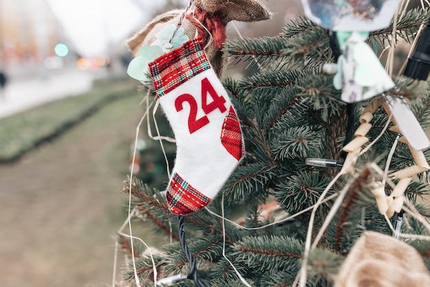 DIY handmade sock with date 24 decoration on Christmas tree