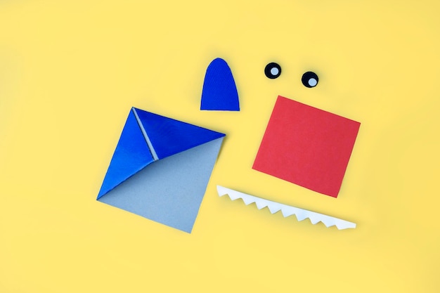 DIY and kids creativity origami bookmark Step by step instruction how to make shark from paper Step8 cut out and glue eyes and fin mouth Children Craft workshop