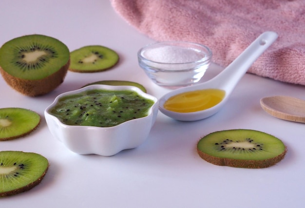 DIY kiwi fruit beauty mask scrub for face or hair in a glass bowl