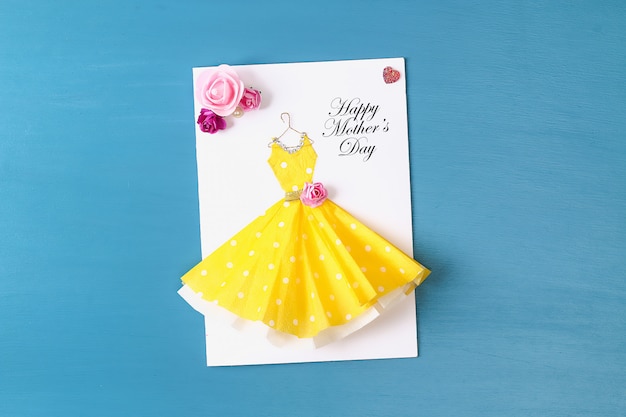 Diy Mothers Day greeting card with a paper napkin dress and flower decoration.