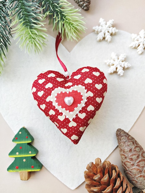 DIY red soft heart for Christmas decoration or for gift. Handmade baubles zero-waste Christmas, flat lay