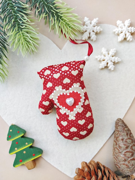 DIY red soft mitten for Christmas decoration. Handmade baubles zero-waste Christmas