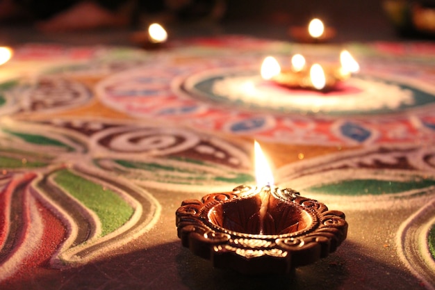 Diya on rangoli at diwali in india