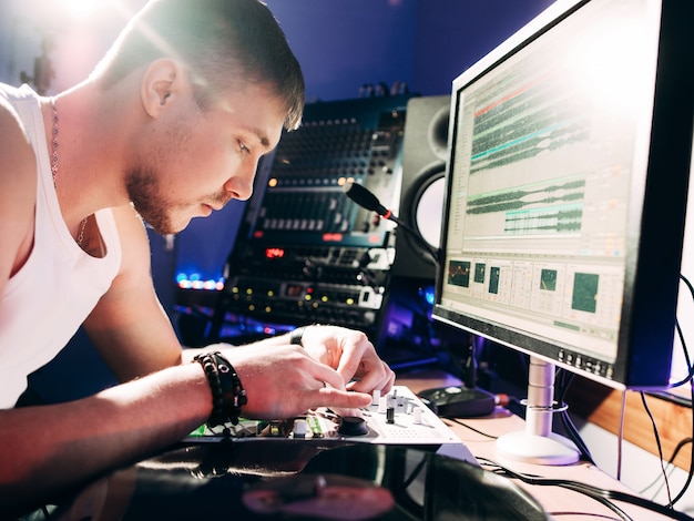 Photo dj adjusting music equipment before work