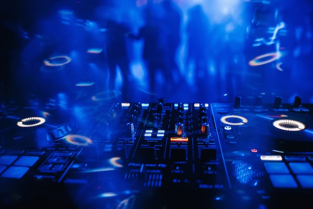 DJ mixer on the table background the night club