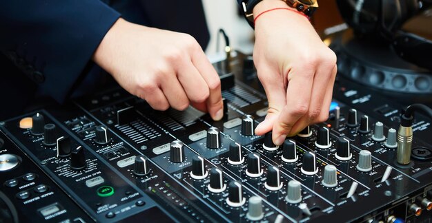 Dj mixes the track in the nightclub at party