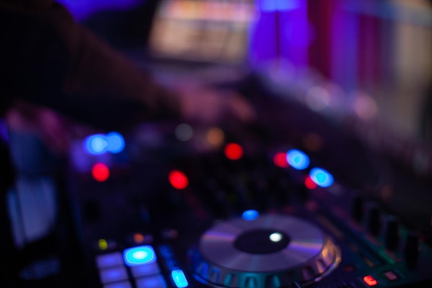 Dj mixing music in night club defocused bokeh music light for background Music dance party time in night club