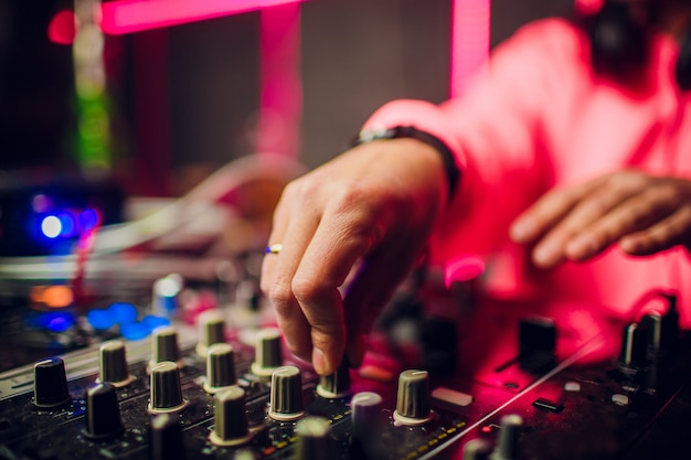 Dj mixing in nightclub at party.