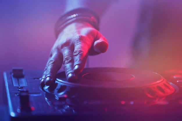 Dj playing music at mixer closeup