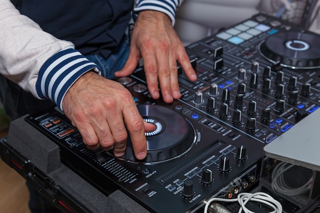 The DJ's hands on the music console. DJ console cd mp4 deejay mixing desk music party in nightclub. DJ console for experiments with music