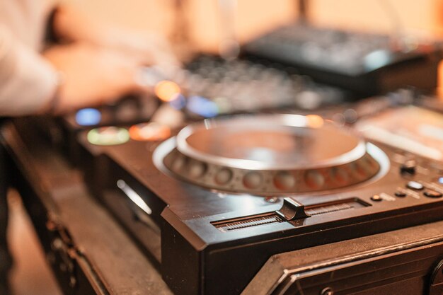 DJ Spinning mixing and scratching in a night club DJ playing music at mixer Closeup Party