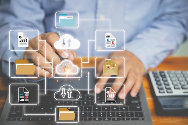 DMS or Document management system concept Businessman use a laptop to document management systems digital online for efficient archiving of company data on the desk in the office