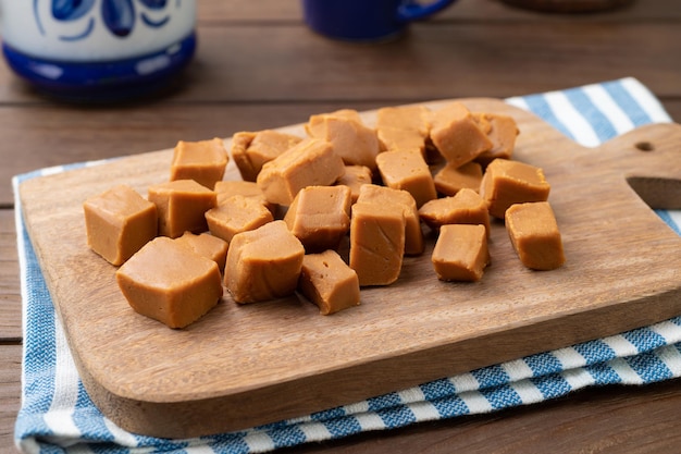 Doce de leite or dulce de leche traditional south american milk candy over wooden board