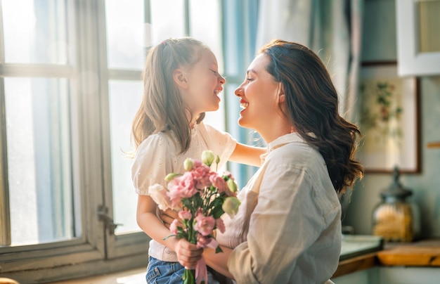 Dochter die moederboeket van bloemen geeft