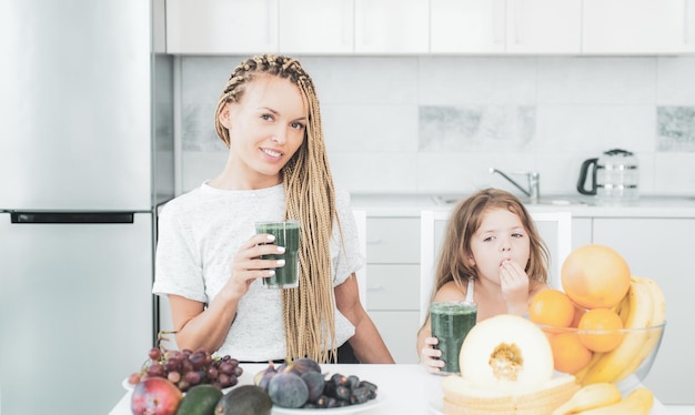 Dochter en haar gelukkige moeder drinken groene smoothie veganistische maaltijd en detoxmenu moeder en dochter dr