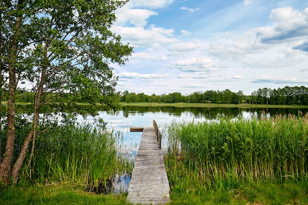 Dock on the banks of the River, sky reflection in water