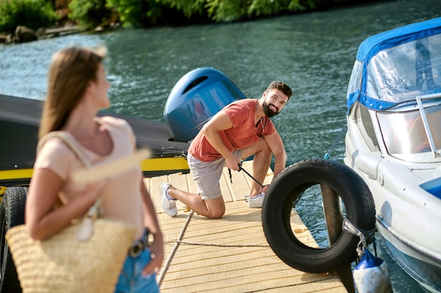 On a dock. A man and a woman near the boat on a dock