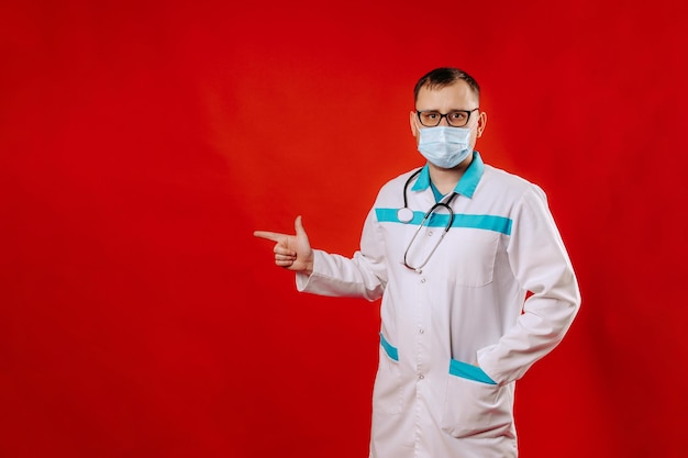 The doctor advertises your product portrait of a doctor Studio shot of young handsome man doctor against