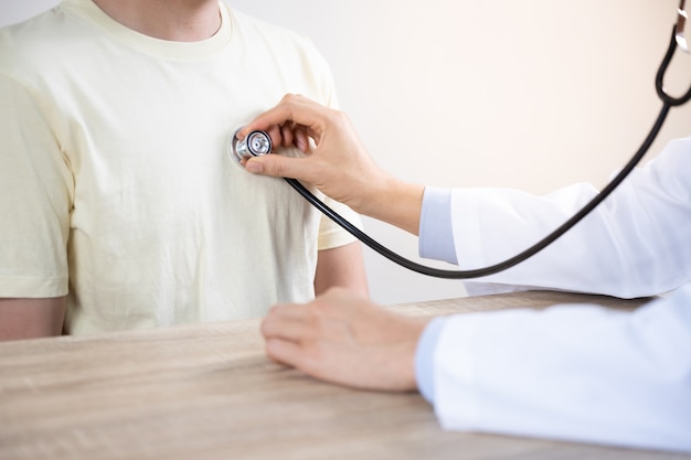 Doctor advice  to man patient in hospital while examining