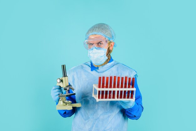 Doctor analyzing blood sample doctor with test tubes and microscope science biology and medicine