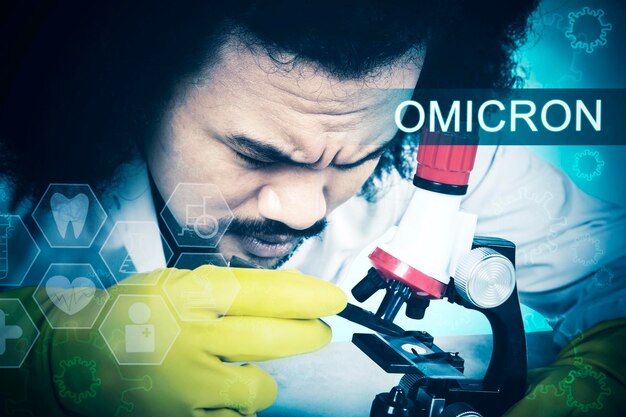 Doctor analyzing covid19 omicron with microscope