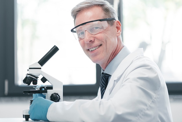 Photo doctor analyzing with a microscope