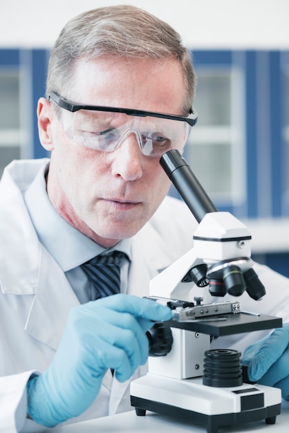 Photo doctor analyzing with a microscope