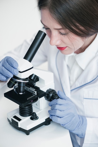 Photo doctor analyzing with a microscope