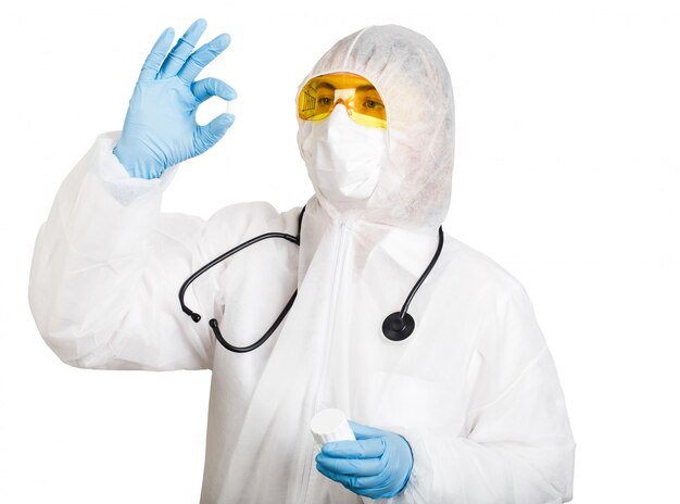 Doctor in anti-epidemic suit holds tablet on white