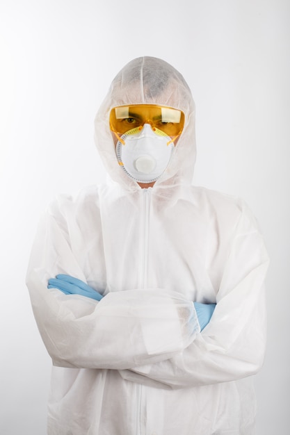 Doctor in anti-epidemic suit on white background