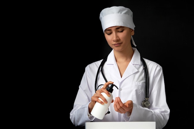 doctor applying antibacterial spray on hand