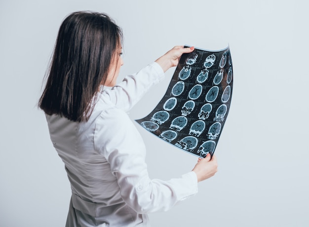 Doctor attentively examines the MRI scan of the patient.