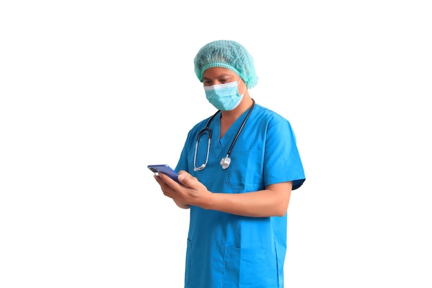 A doctor in a blue scrubs and a stethoscope is using a phone