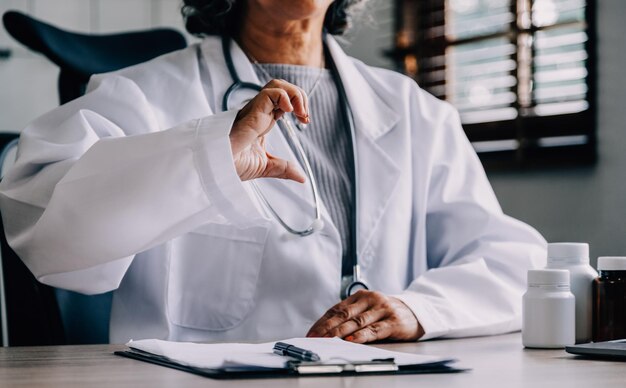 Doctor cardiologist shows heart gesture in clinic closeup