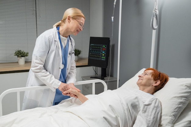 Doctor caring about the elderly woman at hospital