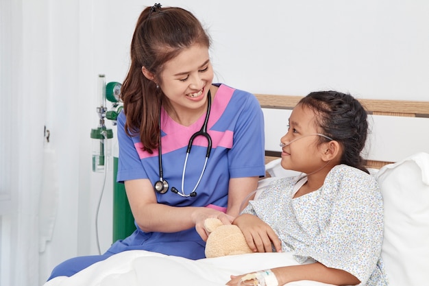 Doctor caring with love little girl in hospital