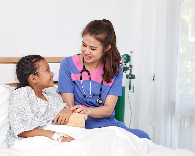 Doctor caring with love little girl in hospital