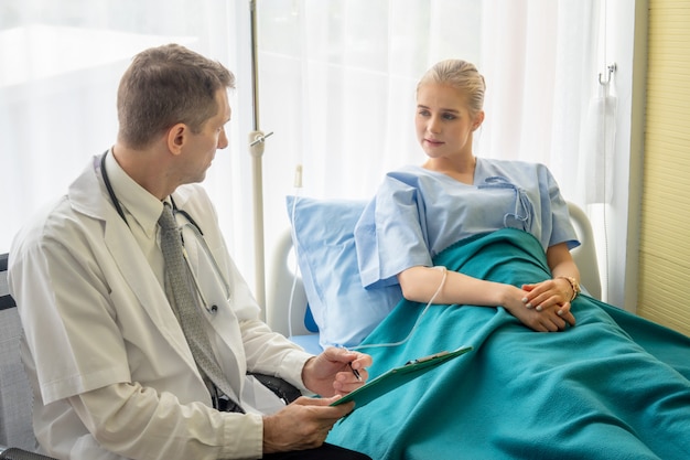 Doctor check up and discuss with patient in clinic or doctor talk with women patient in hospital