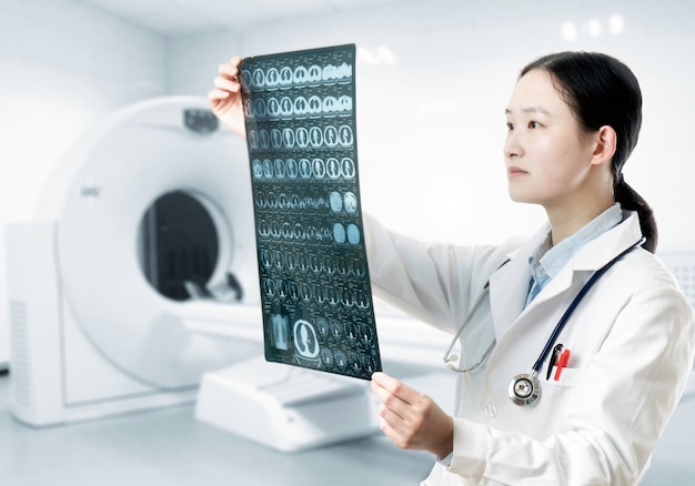 Photo doctor check up x-ray film of the brain by ct scan brain at patient room hospital.