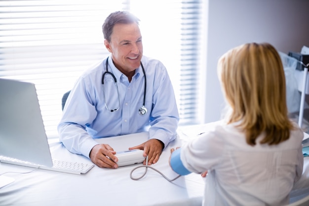 Doctor checking blood pressure of a patient