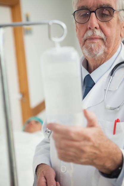 Doctor checking an intravenous drip