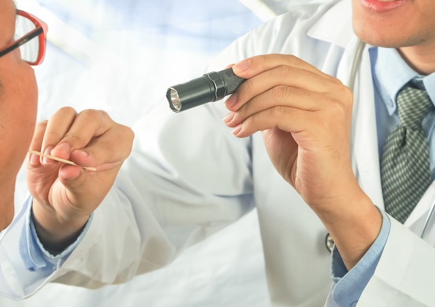 doctor checking mouth throat adult patient 